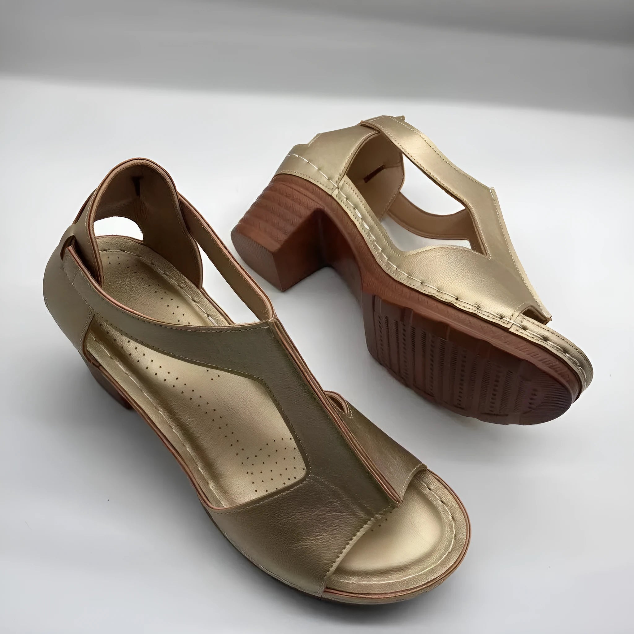 Women's beige peep toe wedge sandals with ankle buckle, shown on a foot.