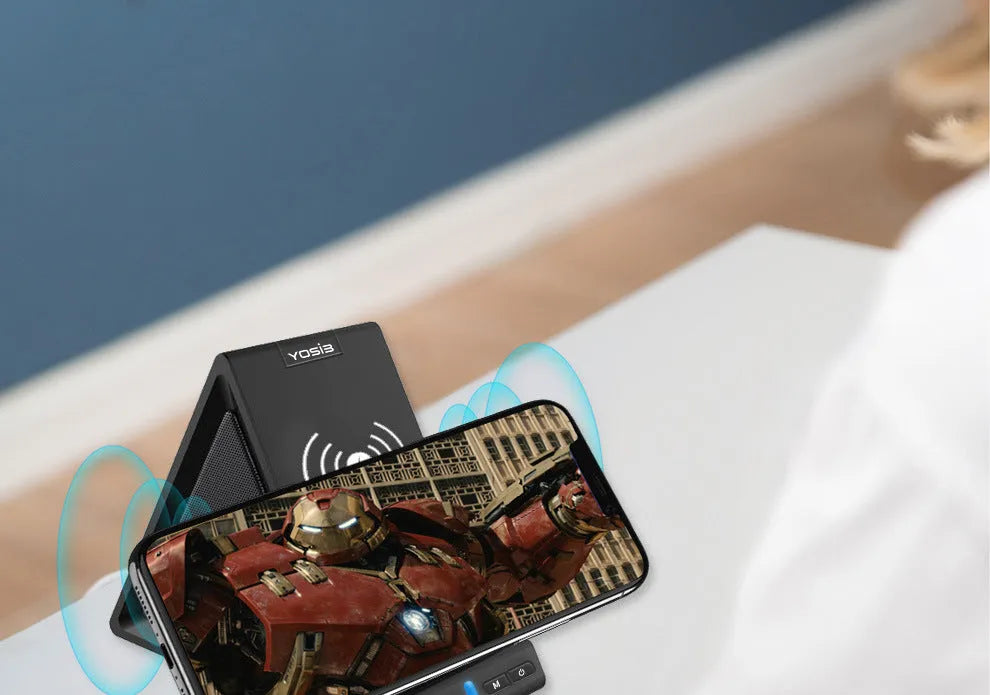 Black multifunctional Bluetooth speaker with integrated phone stand and wireless charging pad