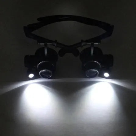 Black hands-free magnifying glasses with LED lights and multiple interchangeable lenses for precision repair work.