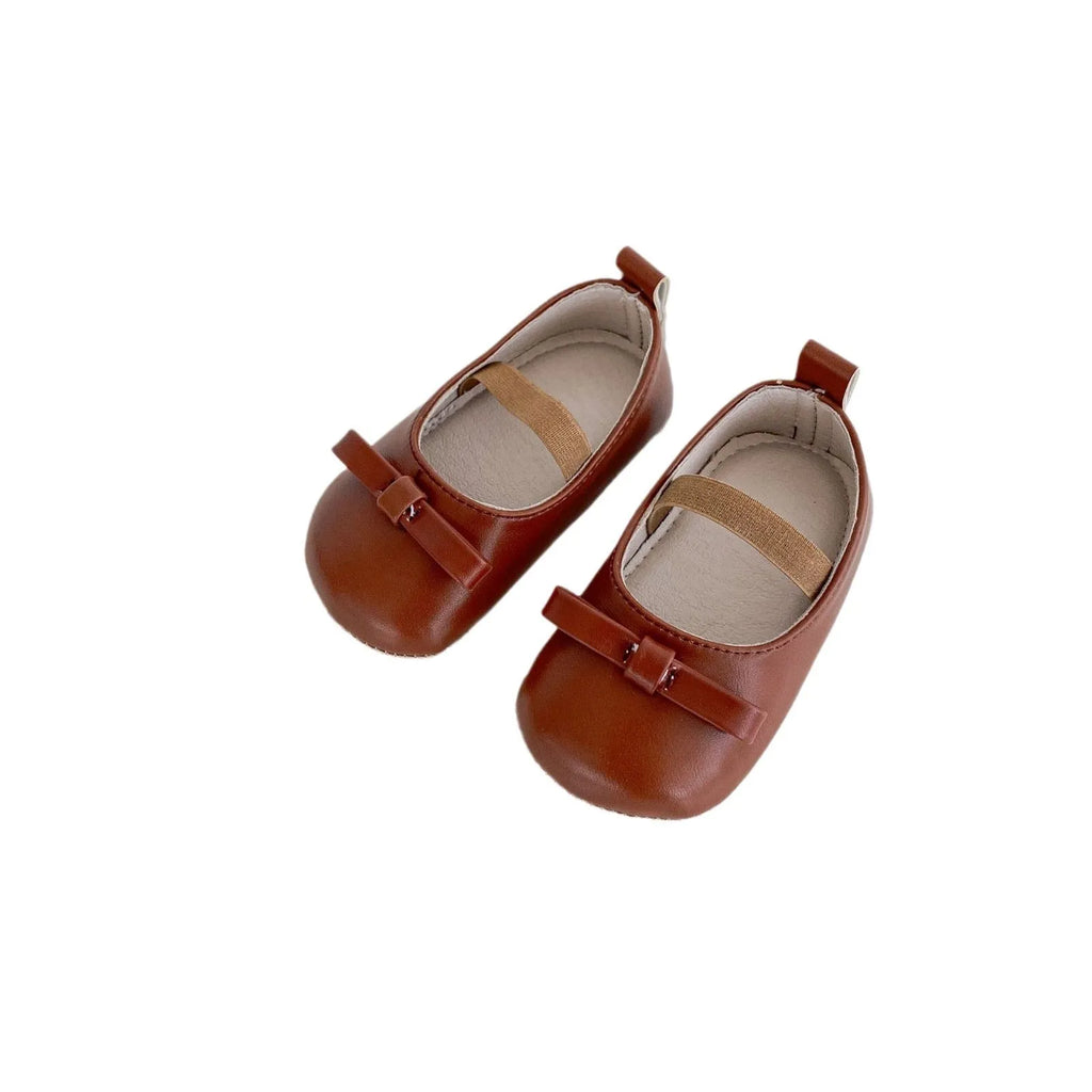 Baby girls' low top shoes with PU upper, rubber non-slip sole, bow detail, and elastic band, in black, white, chestnut brown, or red