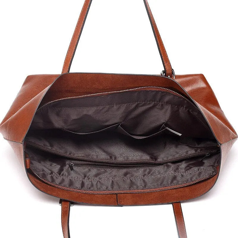 Horizontal wax cowhide leather handbag showing cross-body strap and internal organisation with phone pocket