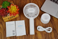 White ORICO FH1 USB rechargeable desk fan with fine-line texture on a desk, showing compact size.