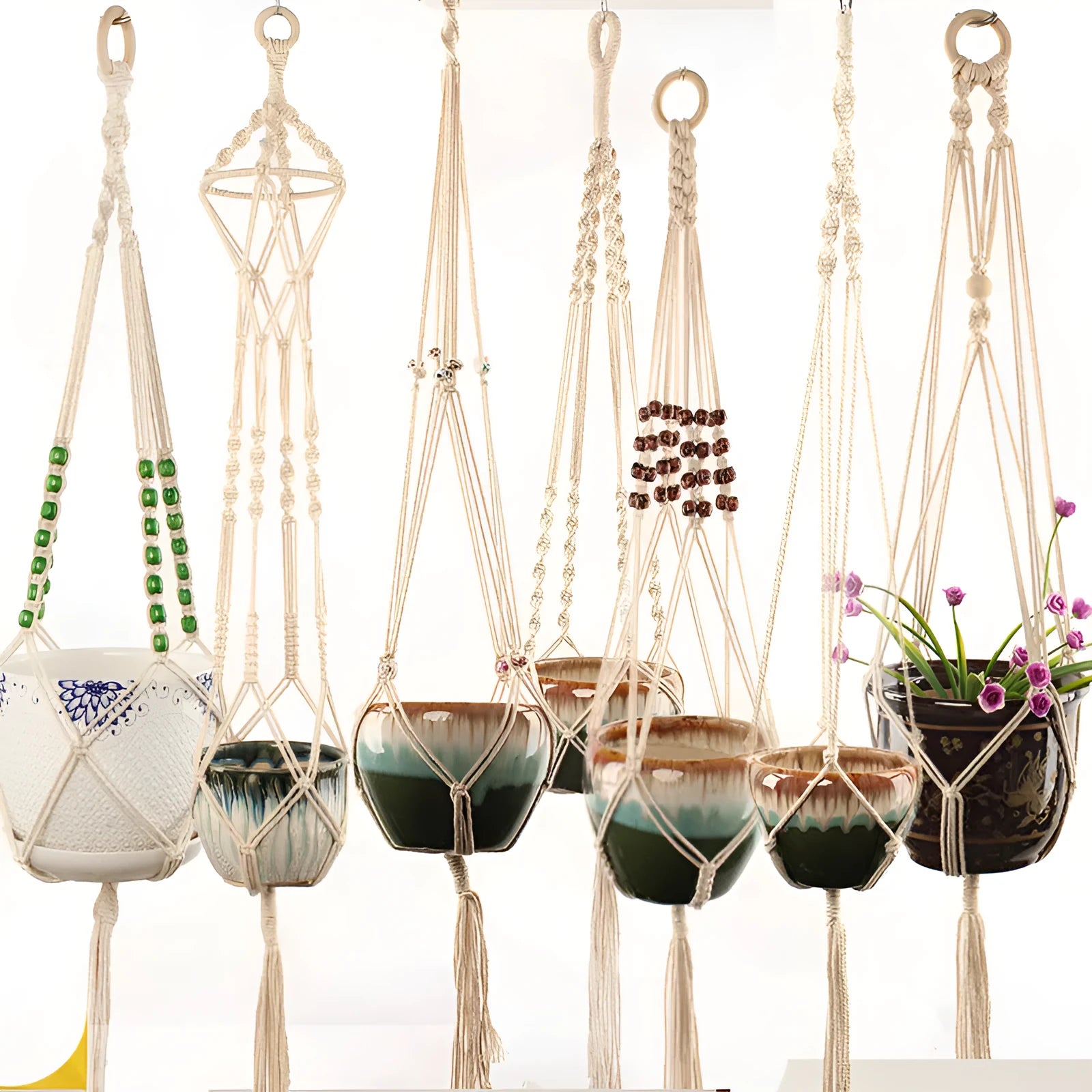 A rustic woven wire plant basket made from cotton rope, holding a green potted plant.