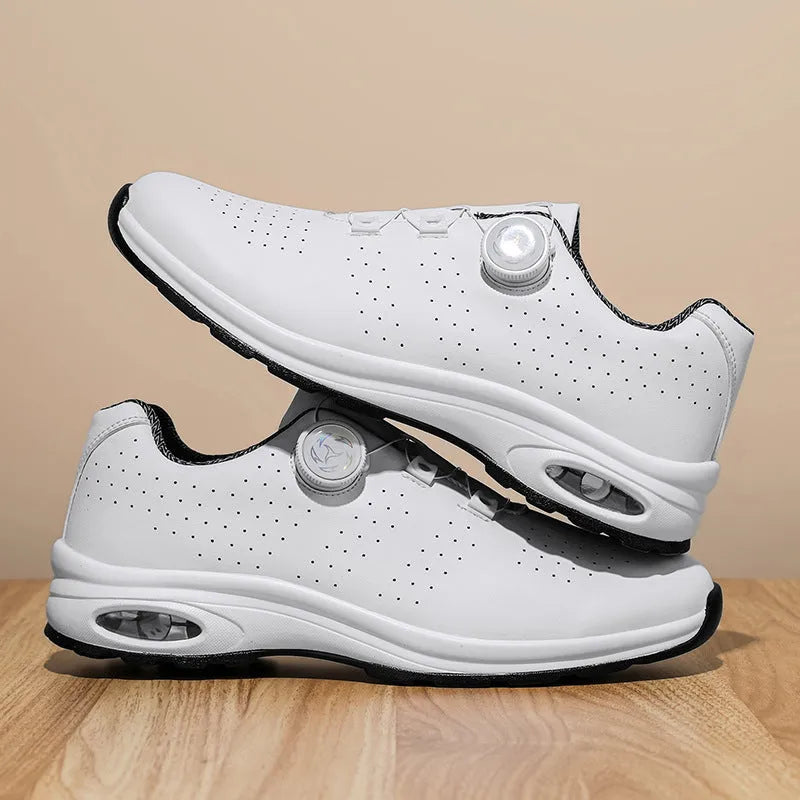 Black and white low top casual tennis shoes with mesh upper, cross shoulder straps, and composite sole.