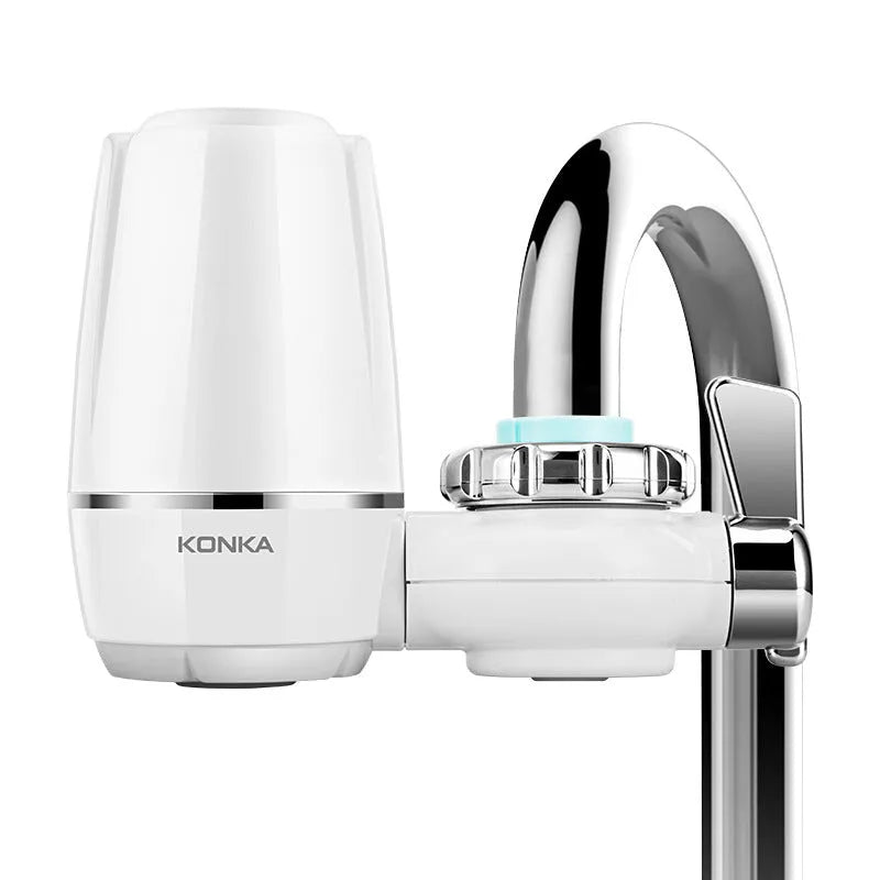 White plastic faucet water filter unit with ceramic core and universal thread adapters for kitchen tap installation.