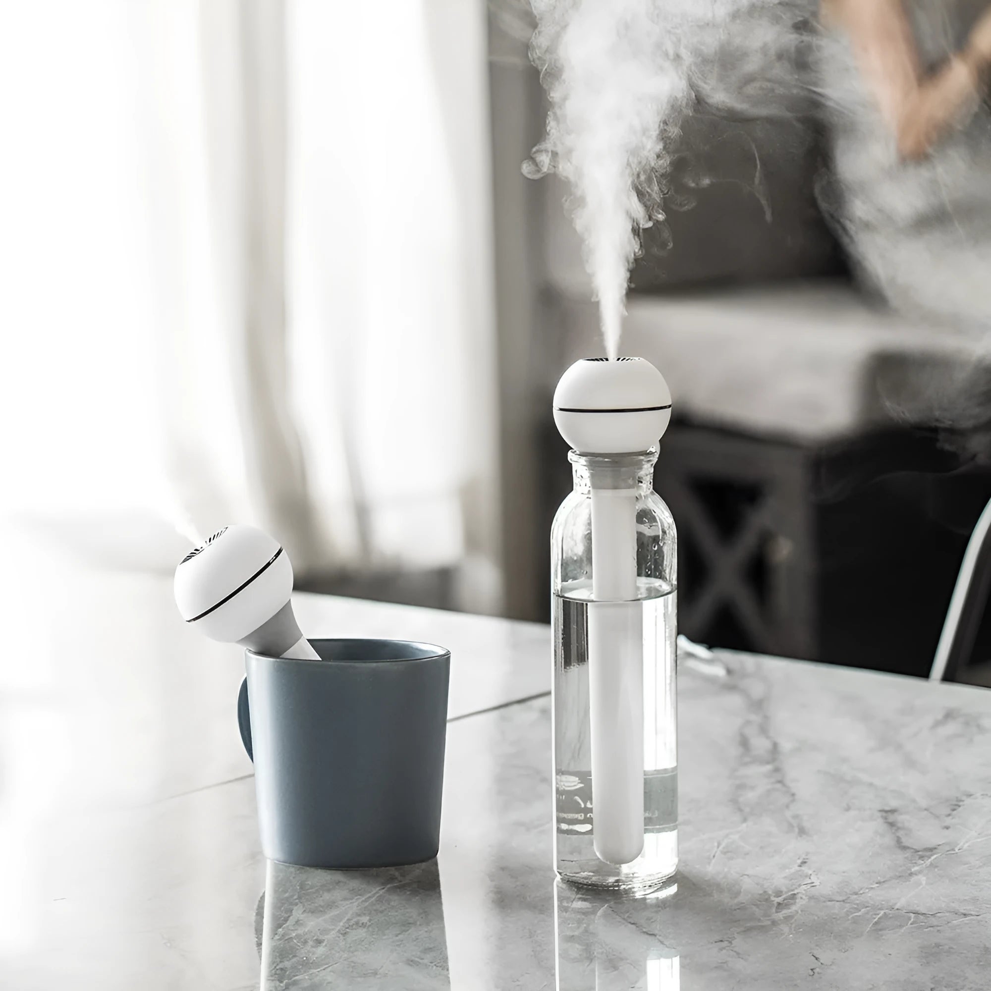 Columnar magic wand style personal humidifier with a 1 litre water tank and mechanical control knob.