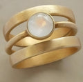 Gold-plated titanium steel ring with geometric hollow design and white chalcedony stone detail