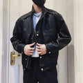 Men's black Korean style PU leather jacket with side pockets and straight hem on a hanger.