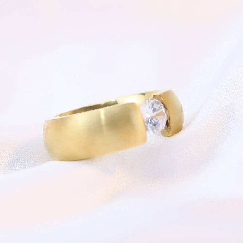 Titanium steel geometric ring with diamond treatment in gold colour finish on white background