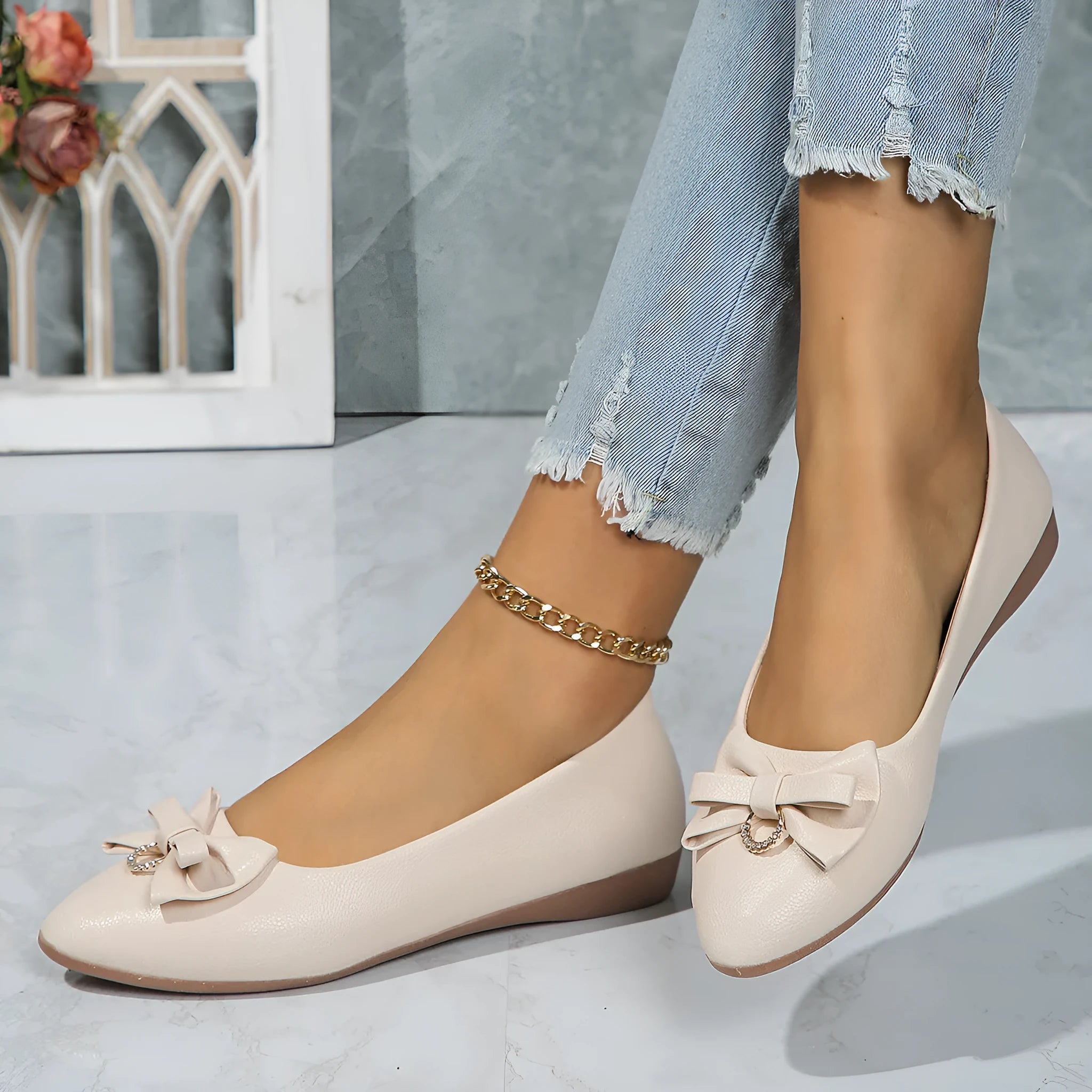 Women's beige flat casual shoes with a bowknot and shallow mouth design on a white background.