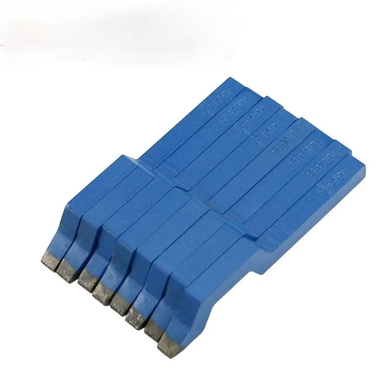 Curved alphanumeric steel stamping tool for jewellery on a metal surface.