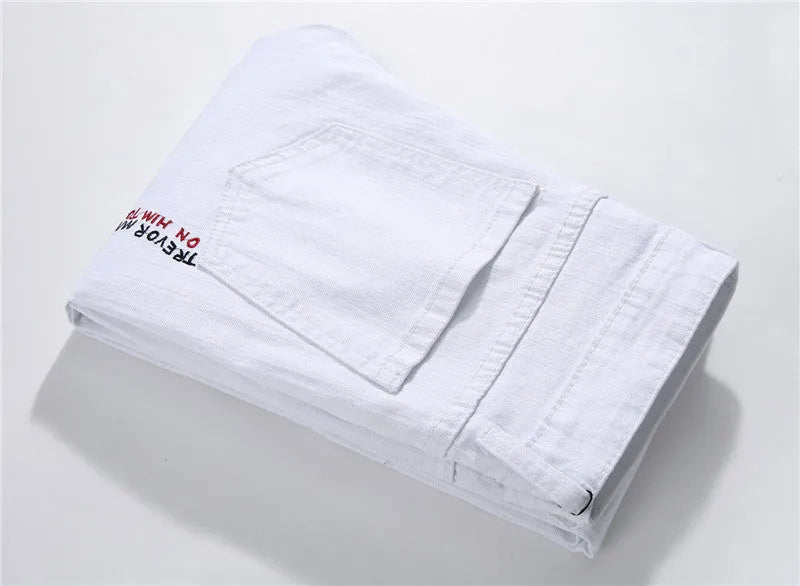 White shredded embroidery jeans in cotton denim, sizes 29-38, with ripped and embroidered details.