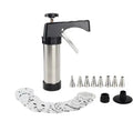 Stainless steel biscuit press gun with assorted cookie moulds and icing nozzles on a baking sheet.