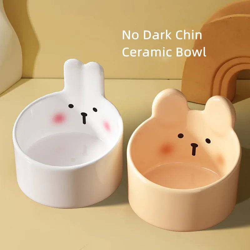 White and yellow ceramic pet feeding bowls with animal patterns in large and small sizes