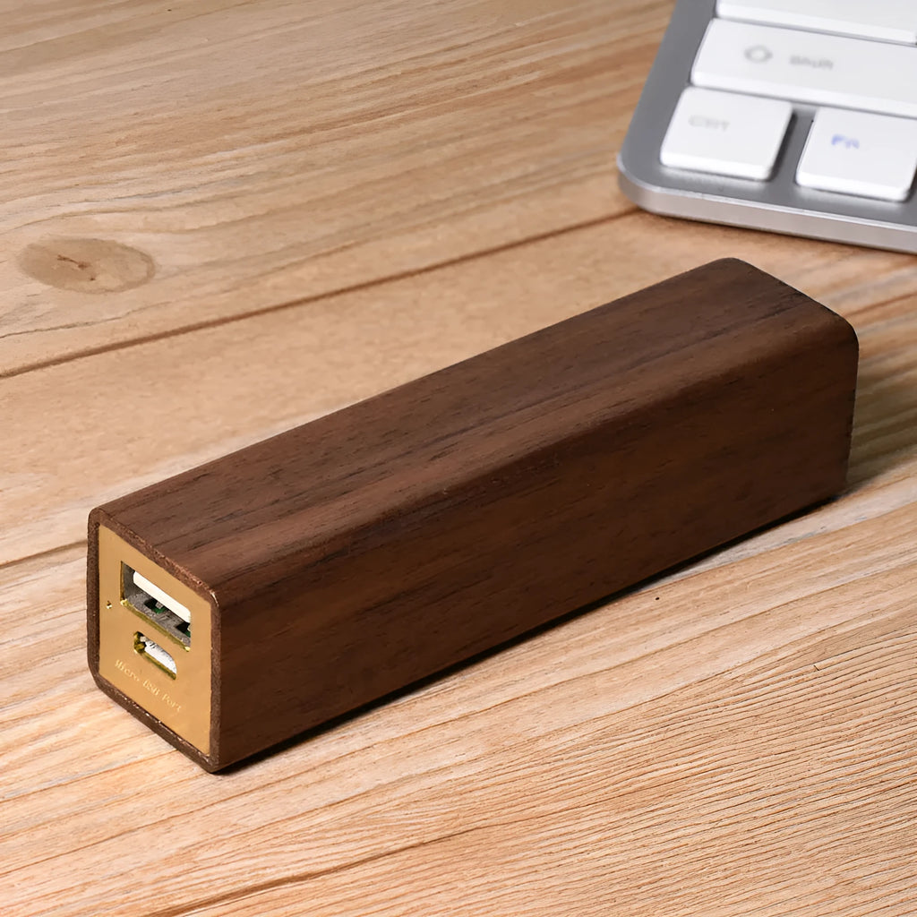 Portable power bank with brown walnut wood shell showing charging ports