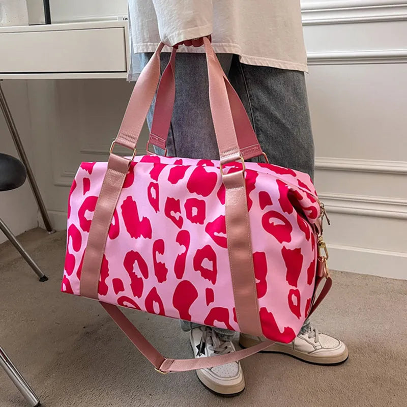 Women's large travel duffel bag with cow pattern, black, showing zippered main compartment and soft handle