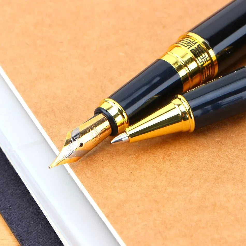 Black metal fountain pen with iridium nib and patterned orb design, shown on a desk