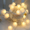 LED pine cone decorative light string with warm white bulbs and plastic shells, battery powered for flexible placement