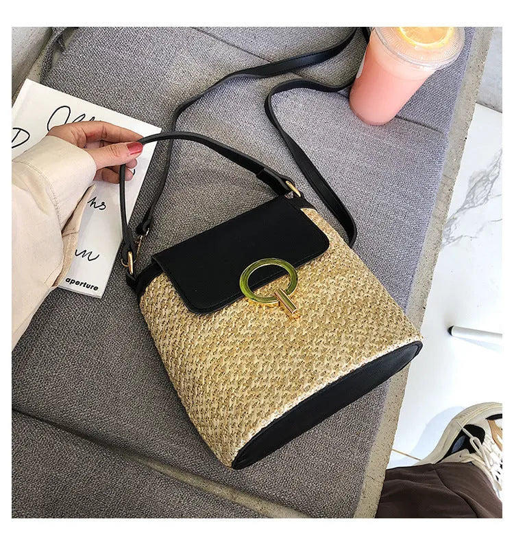 Women's straw woven bucket shoulder bag in black with cover flap, small size, polyester lining