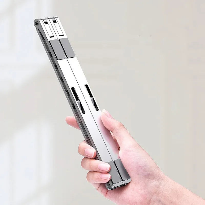 Folding aluminium alloy laptop stand in grey with silicone pads, angled to show ten gear adjustment