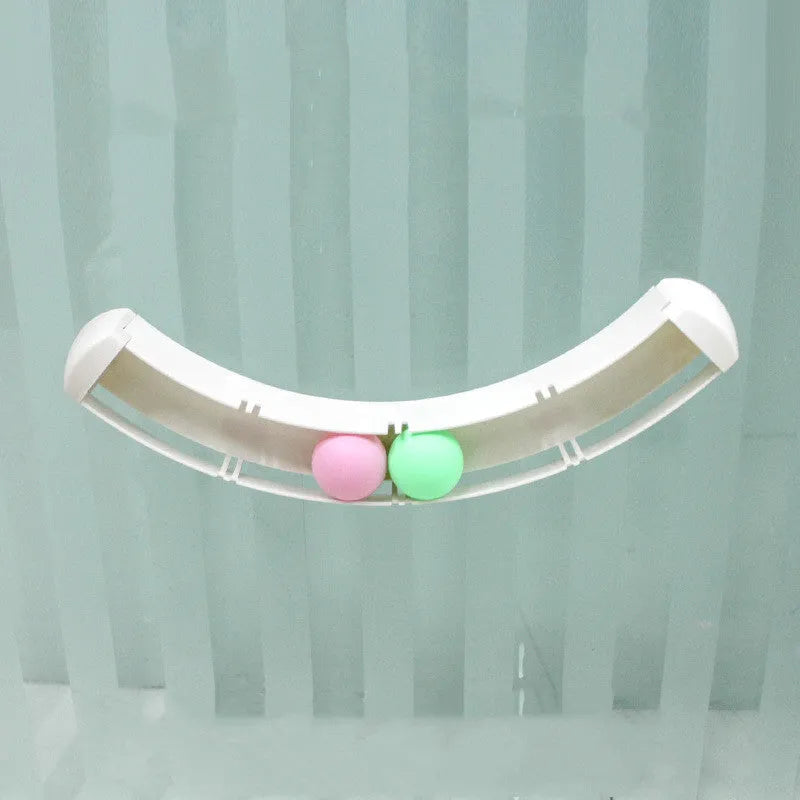 White plastic curved cat track toy, 34cm, fixed to a smooth surface with two small balls in the channel