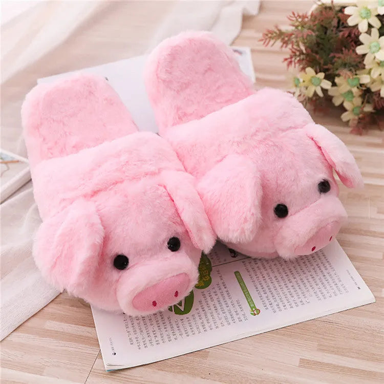 Pink plush pig face design floor slippers on a white background.