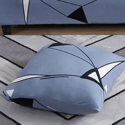 Geometric patterned stretch sofa slipcover on a modern three-seater sofa.