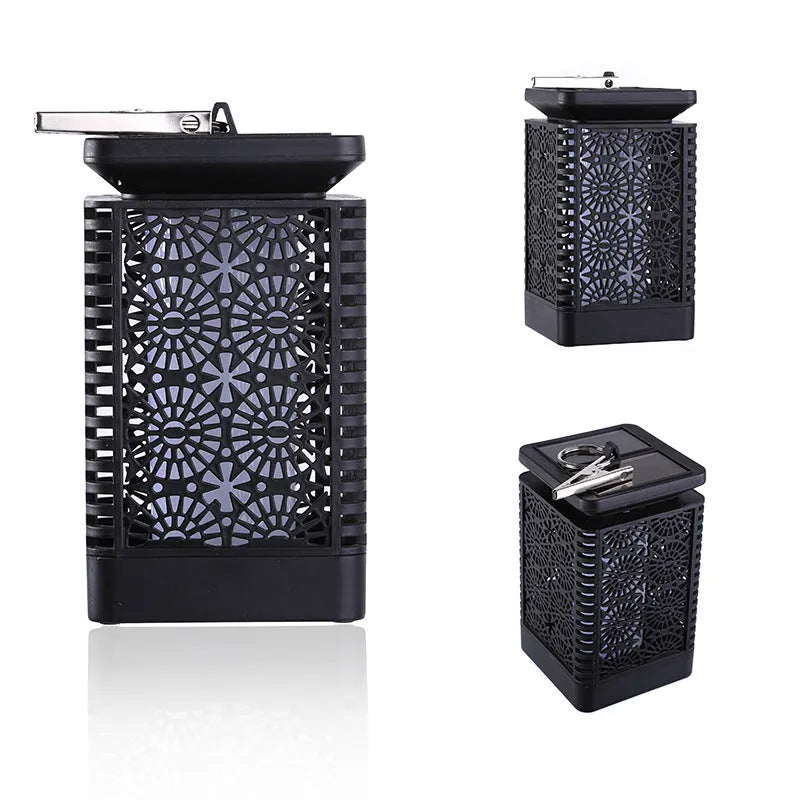 Grey retro-style solar lawn light with flame effect LED, placed in a garden.