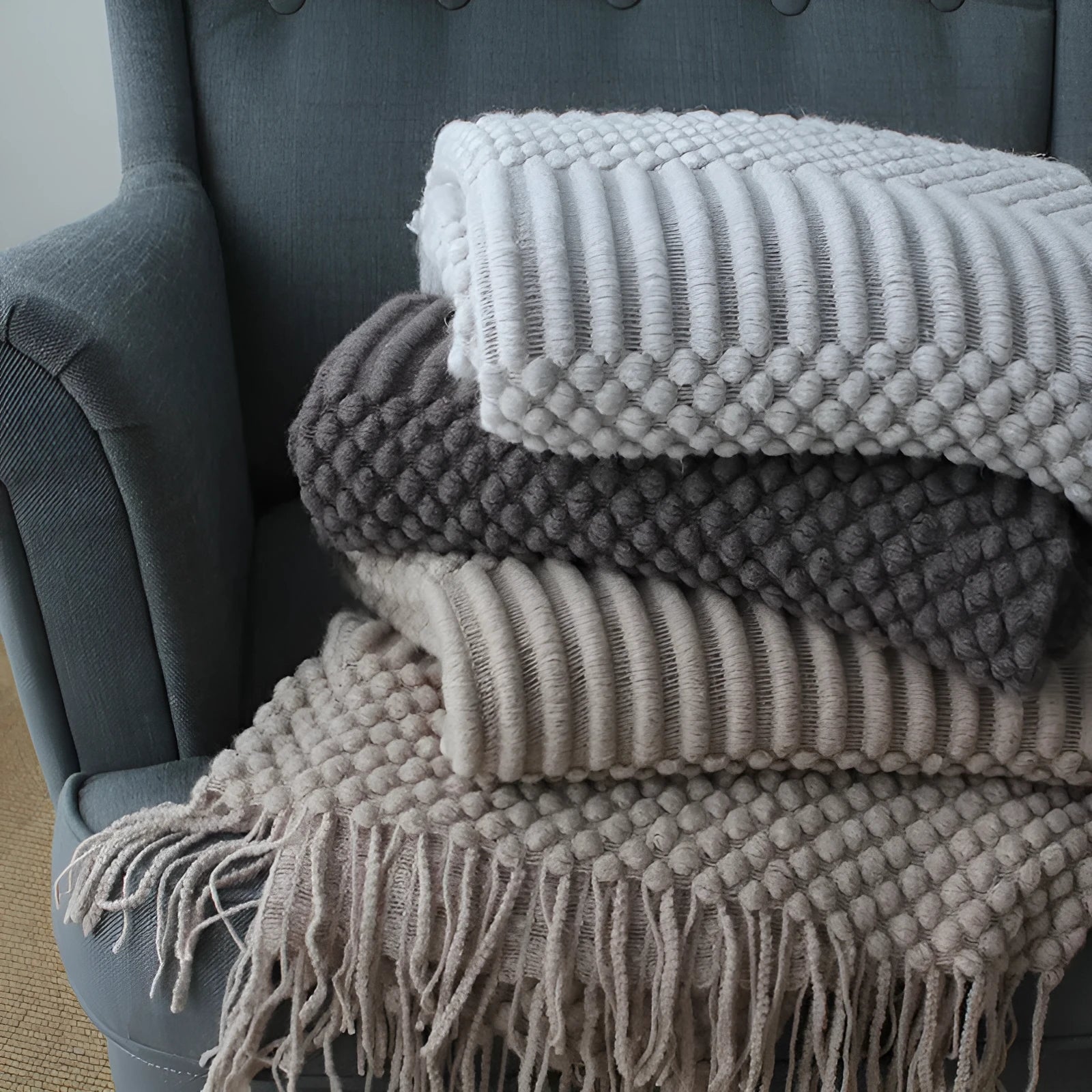 Small light grey polyester nap blanket laid flat showing 127x170cm size.