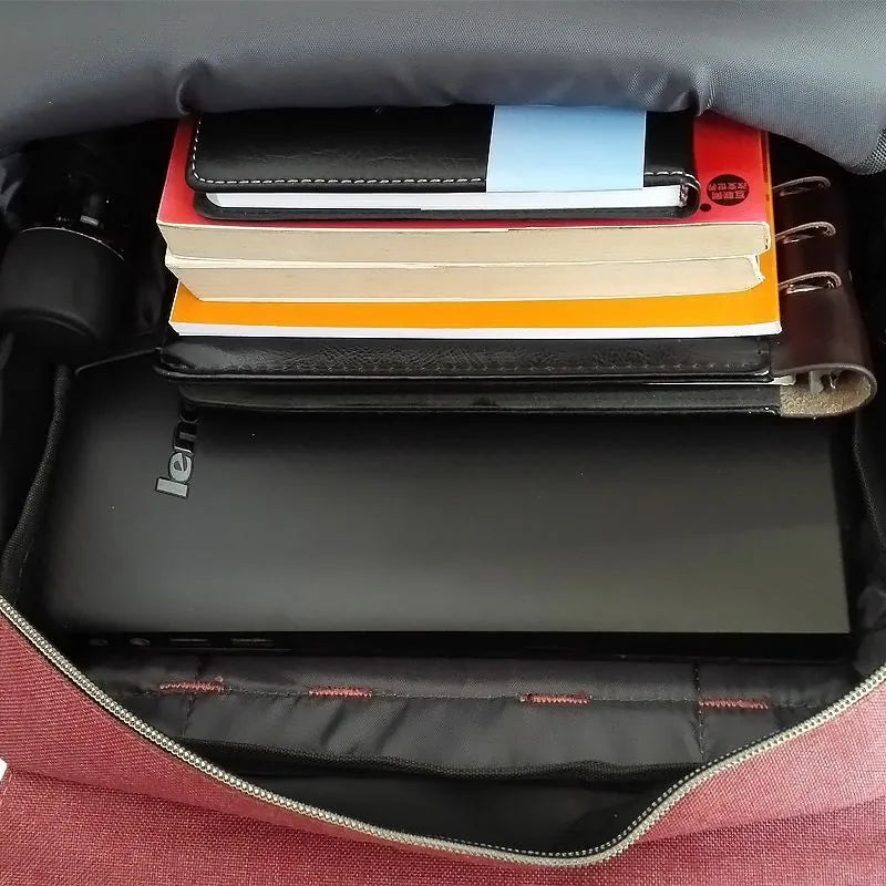 Canvas computer backpack in nylon waterproof cloth with 40x29x12cm dimensions, front view, black colour option, lightweight sports fashion design.