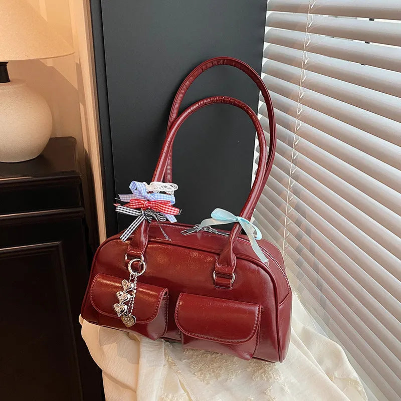 Women's black PU leather retro pillow handbag with double shoulder strap and flap closure.