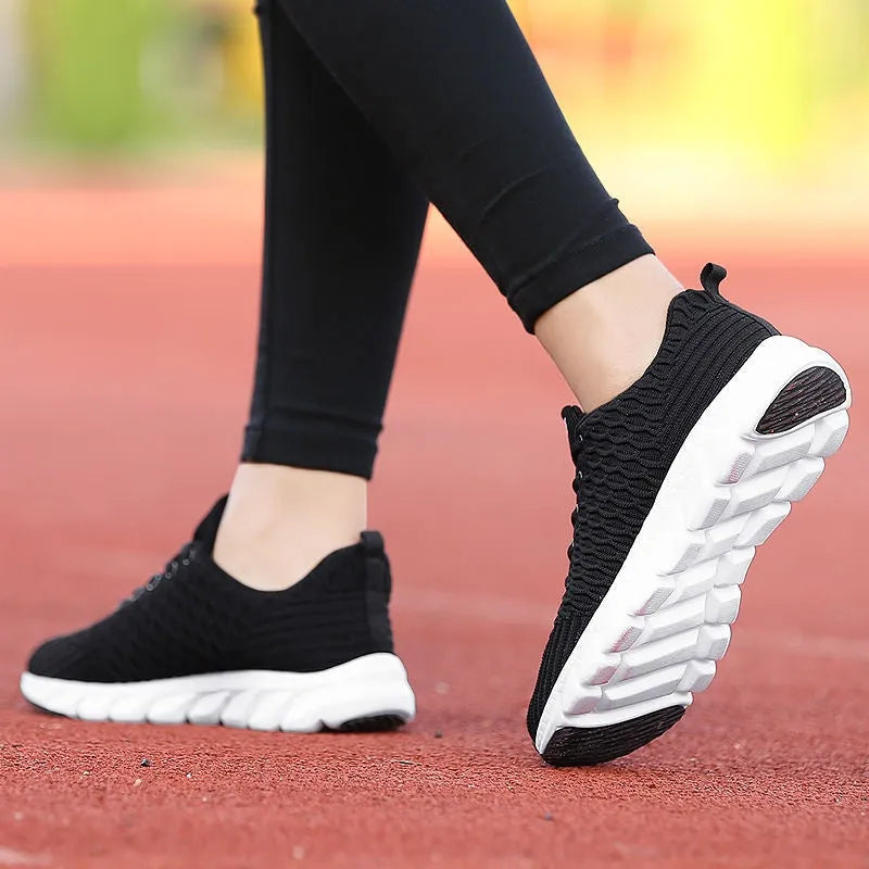 Women's running shoes in black, pink, or white with fly weave upper and wear-resistant sole