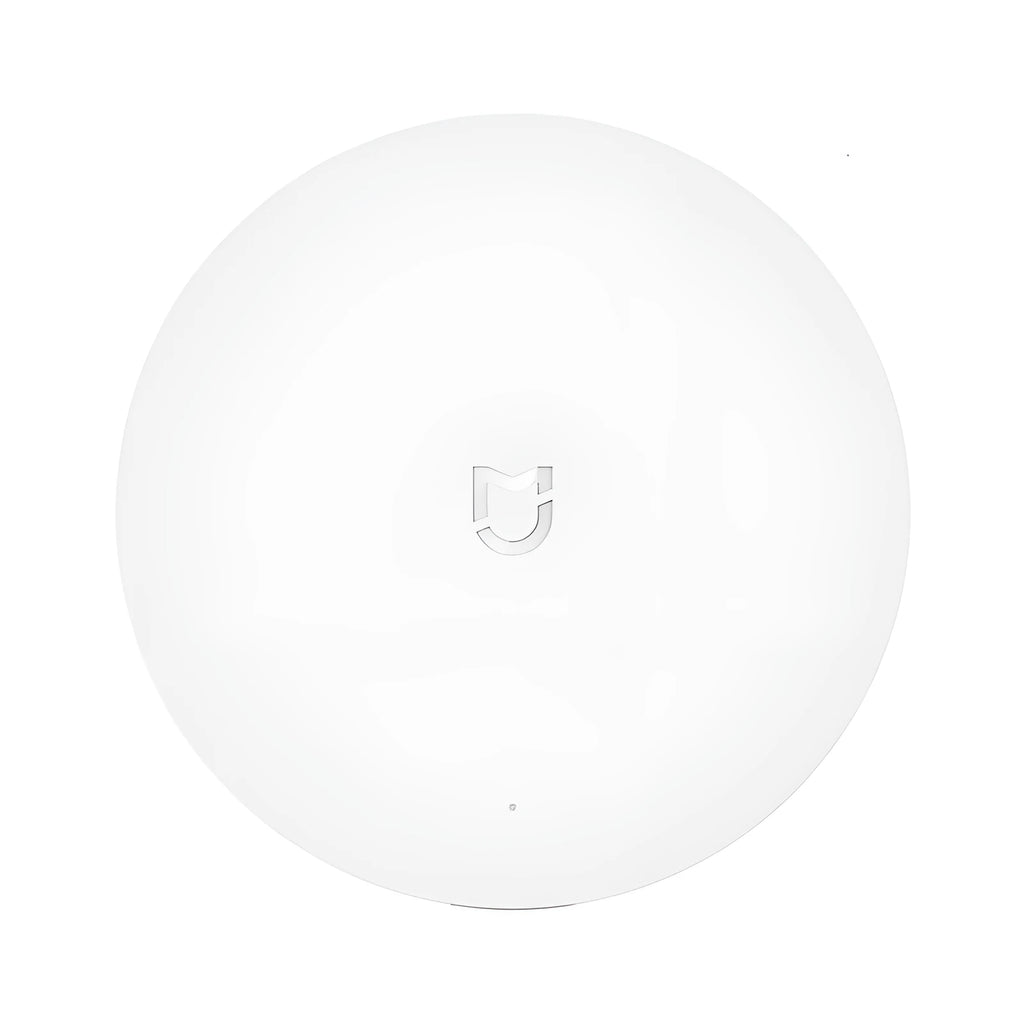 White circular smart home gateway with UK plug for wireless wall control