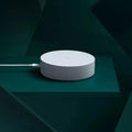 White circular smart home gateway with UK plug for wireless wall control