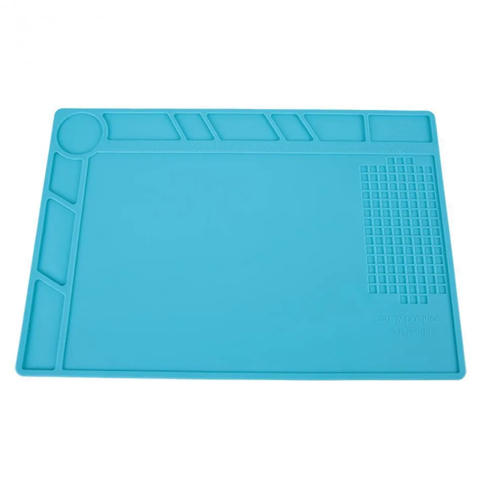 Blue silicone watch repair desk mat lying flat on a workbench.