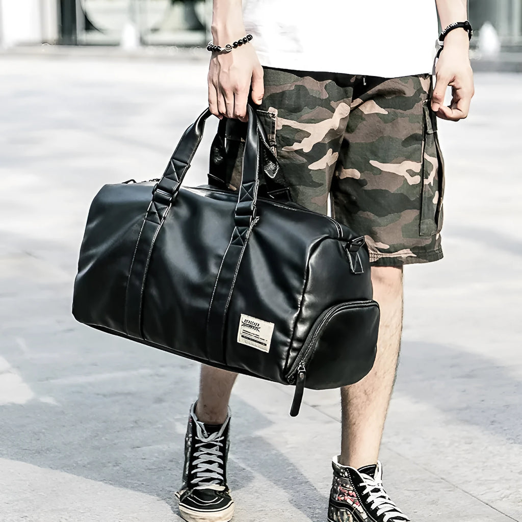 Black waterproof PU leather sports training bag showing multiple internal compartments and carrying handles
