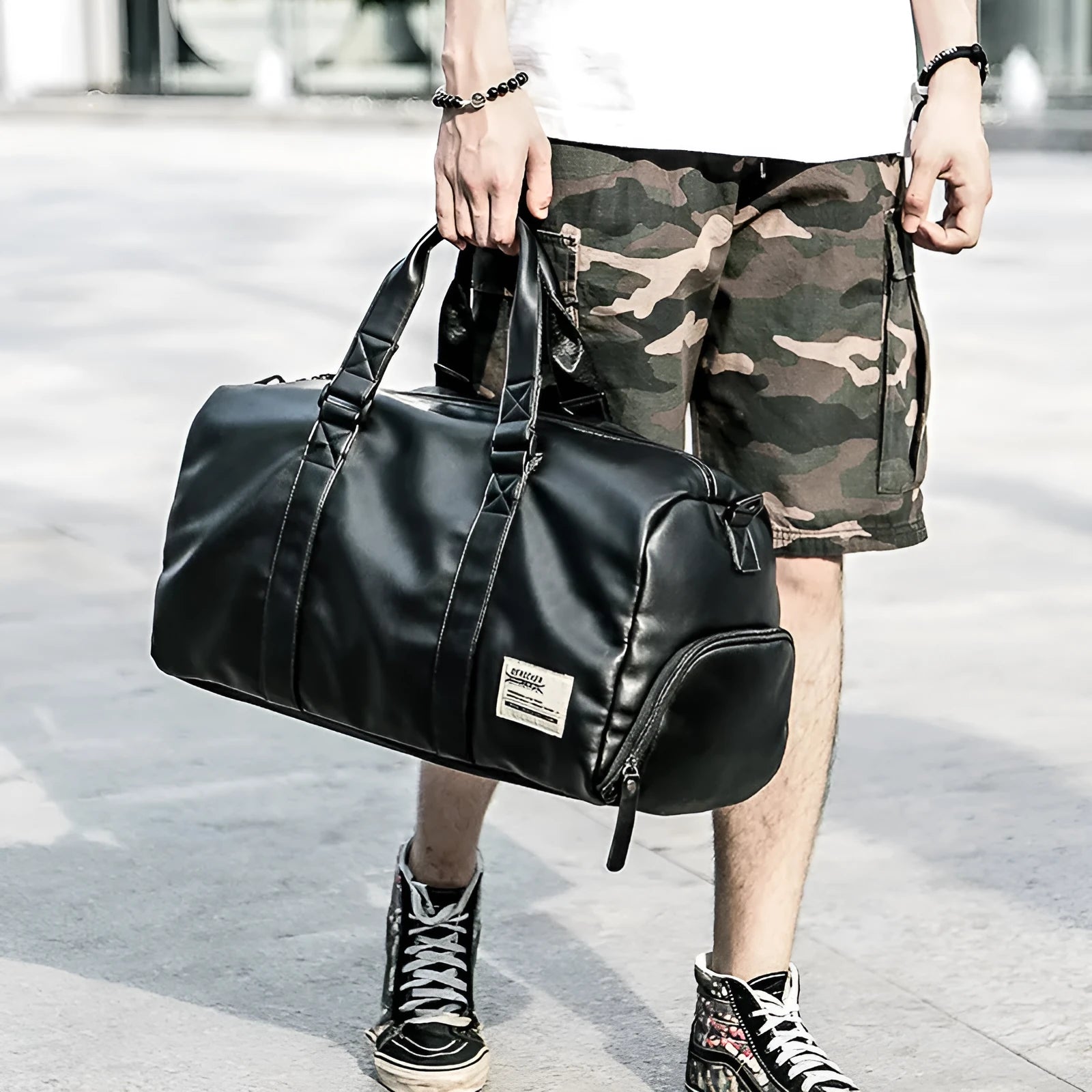Black waterproof PU leather sports training bag showing multiple internal compartments and carrying handles