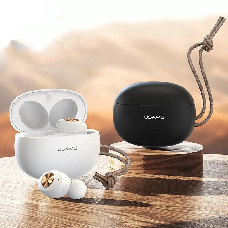 Pebble Series white wireless Bluetooth earbuds next to their compact charging case.