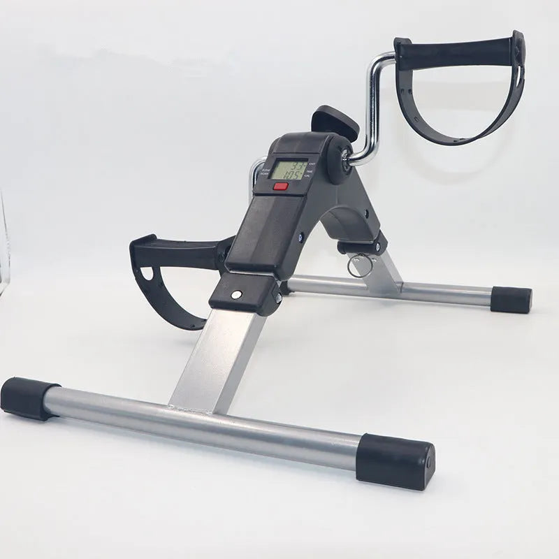 Black mini bike leg trainer with mechanical resistance, rubber and steel body, 36cm by 48cm by 23.3cm