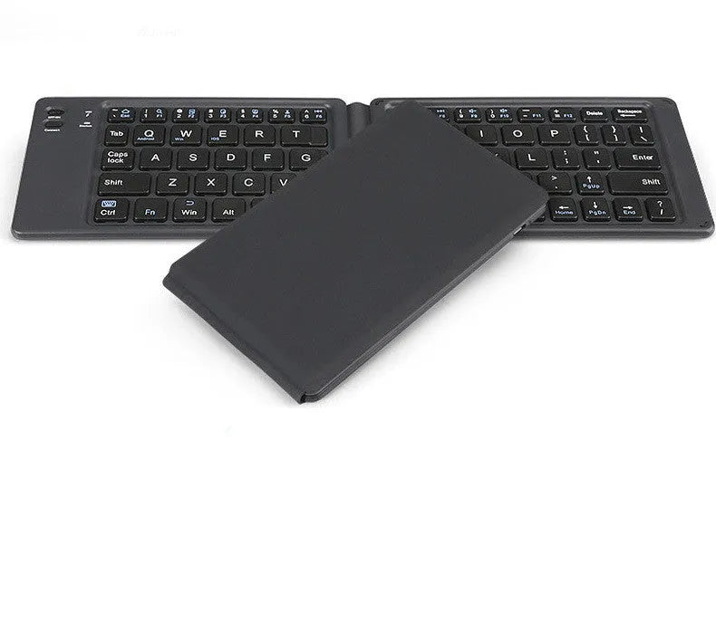 Folding Bluetooth keyboard in ABS with 64 keys, open on desk with iPad