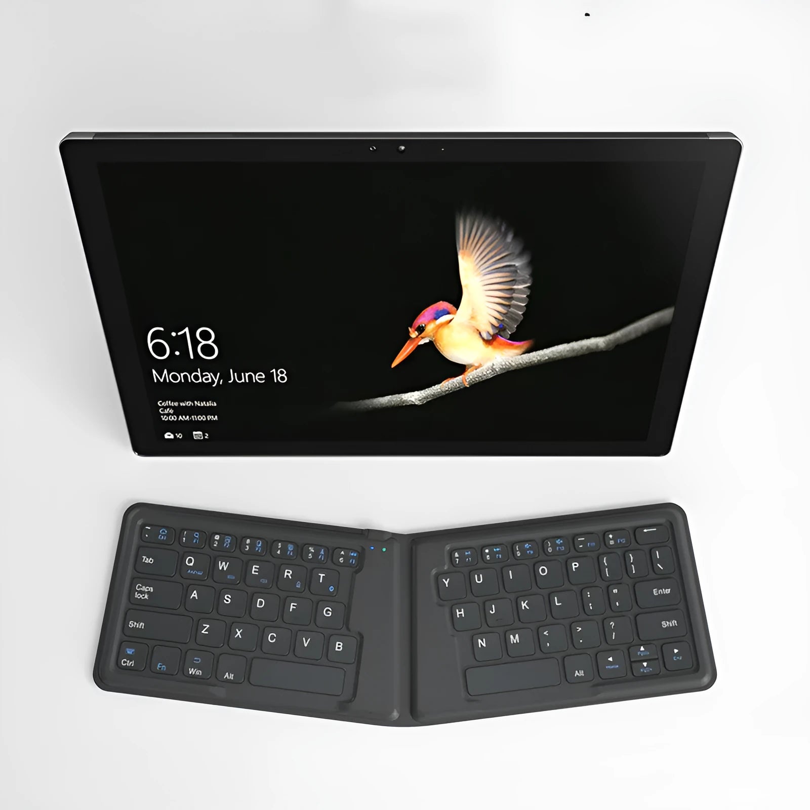 Folding Bluetooth keyboard in ABS with 64 keys, open on desk with iPad