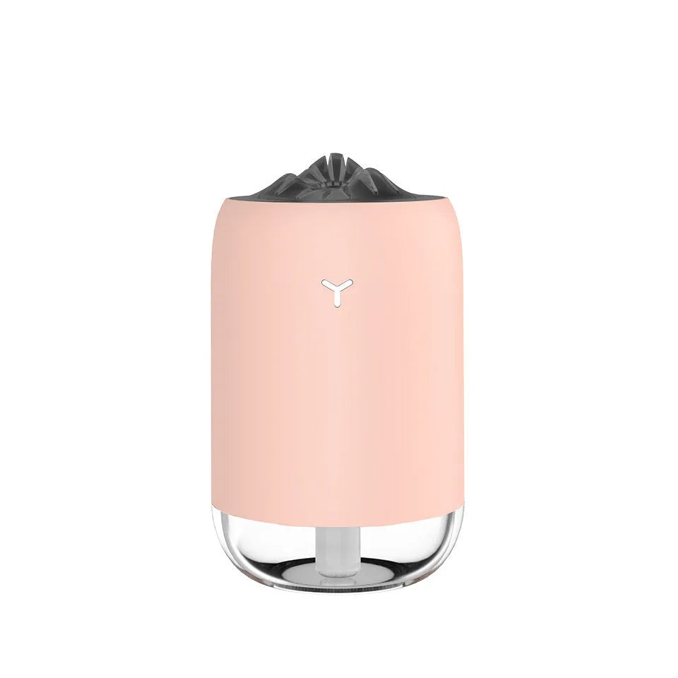 Magic Flame columnar ultrasonic humidifier in light blue colour on a desktop, showing mist output and USB cable.