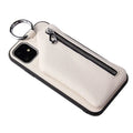 Pink imitation leather crossbody lanyard attached to a phone case on a table.