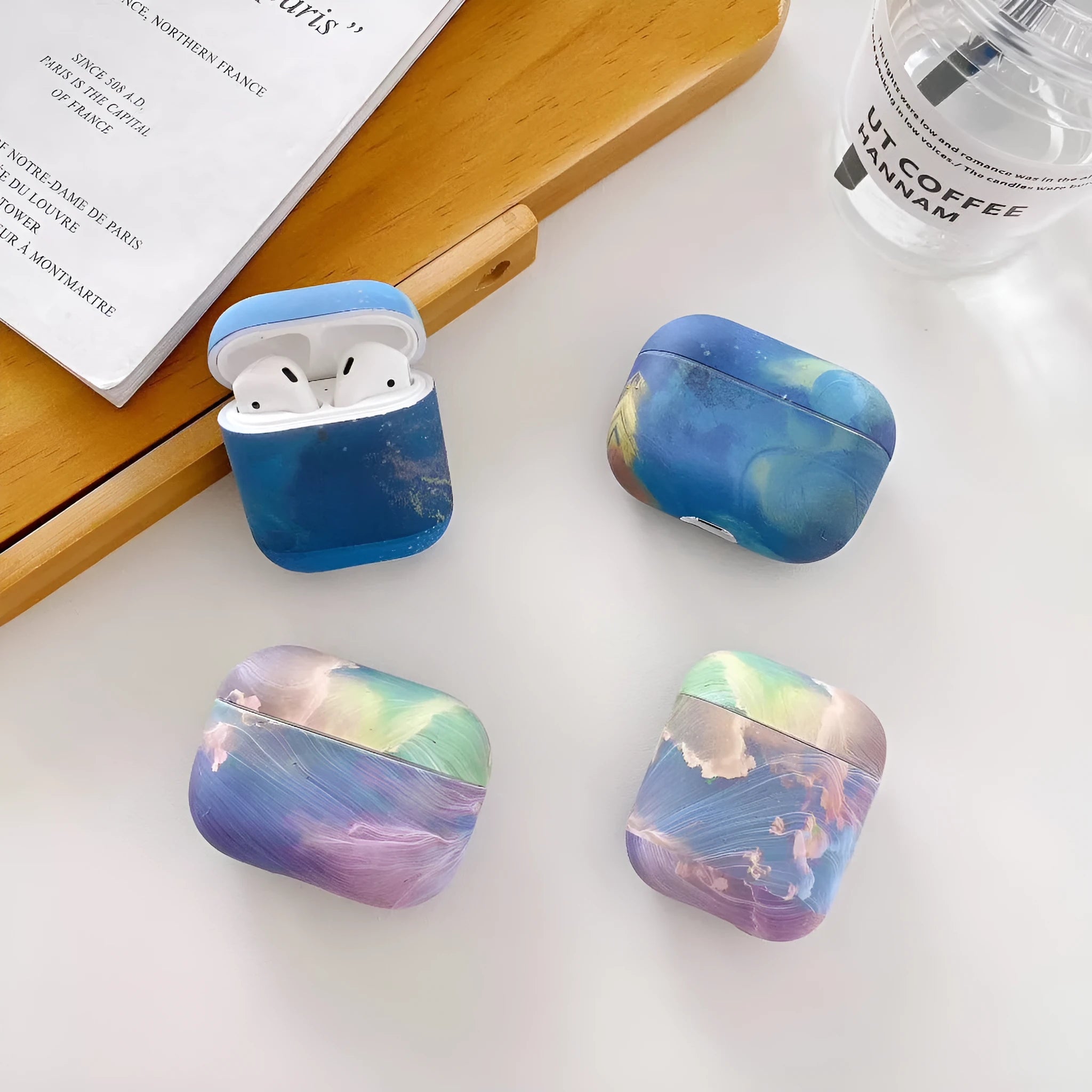 Hard shell protective sleeve for Apple AirPods with watercolour design in pink or blue colour options