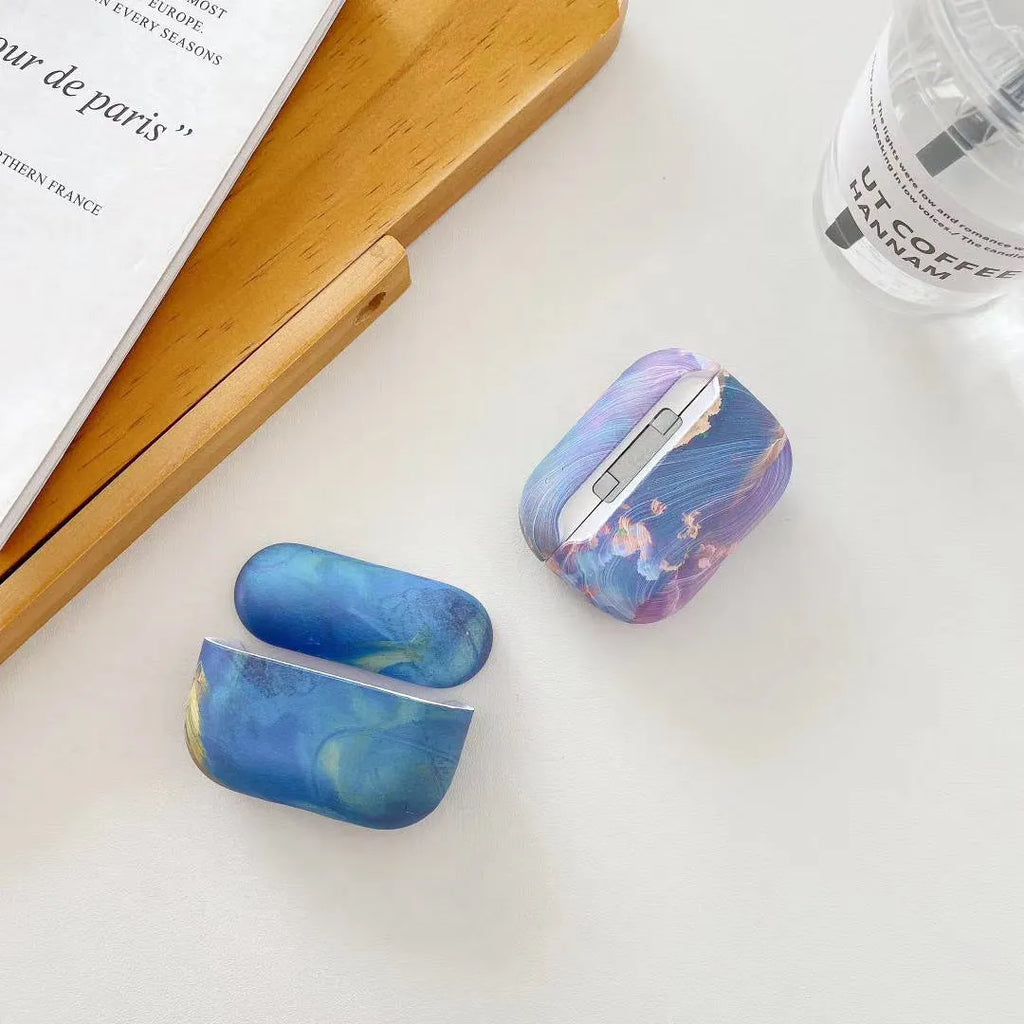 Hard shell protective sleeve for Apple AirPods with watercolour design in pink or blue colour options
