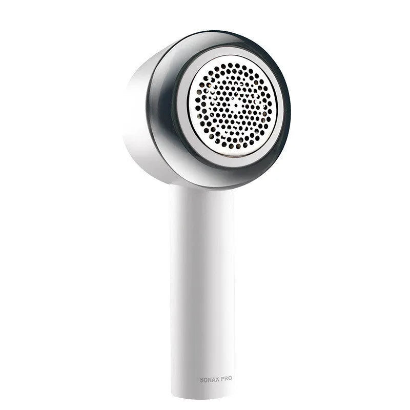 White rechargeable clothes shaver and fabric pill remover on a wooden surface.