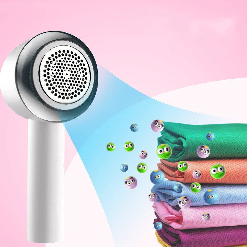 White rechargeable clothes shaver and fabric pill remover on a wooden surface.