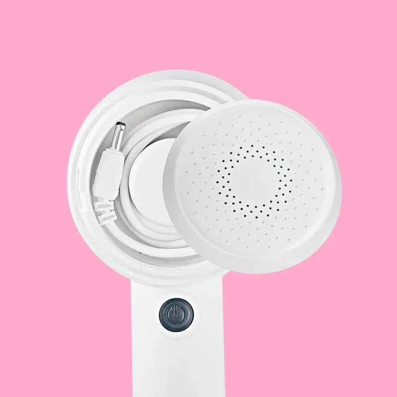 White rechargeable clothes shaver and fabric pill remover on a wooden surface.
