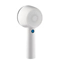 White rechargeable clothes shaver and fabric pill remover on a wooden surface.