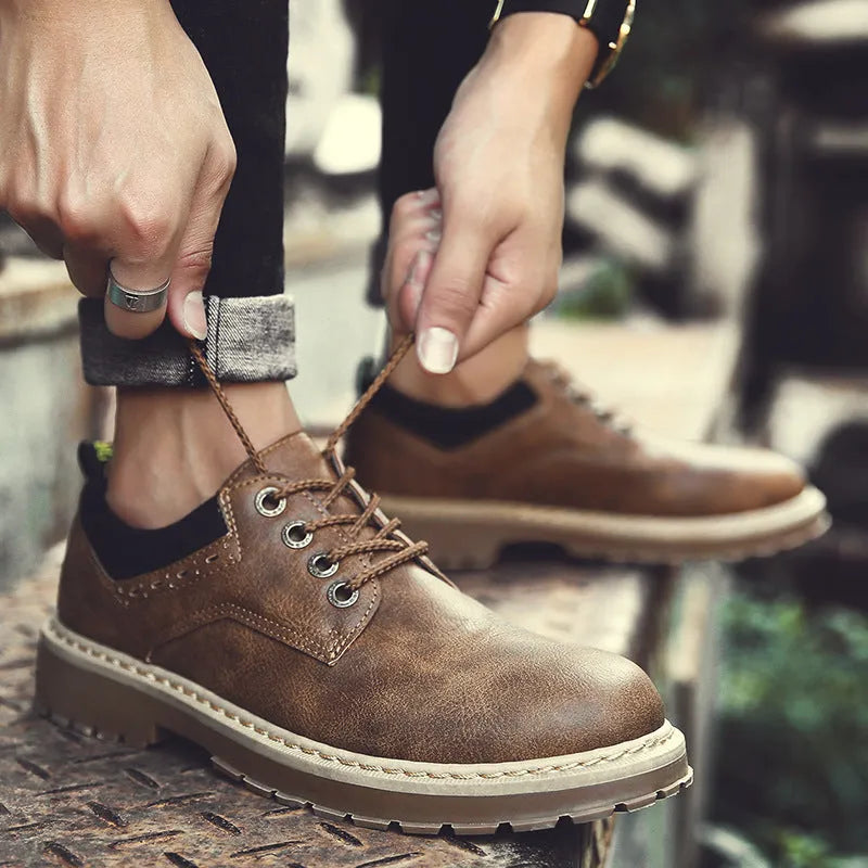 Men's black casual lace-up shoes with a round toe and low-top design on a rubber sole.